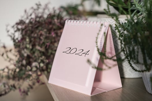 Desk calendar 2024 on a shelf among house plants photo