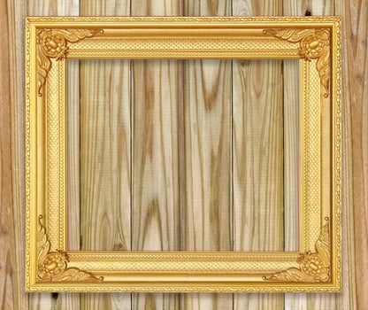 Antique gold frame on white wooden wall Empty picture frame on white wooden wall. photo
