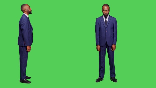Disappointed office worker nodding head on camera, showing disapproval and rejection in studio. Frustrated entrepreneur being upset and expressing denial over full body greenscreen. photo
