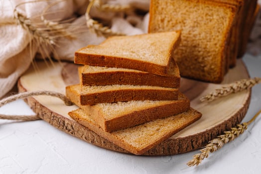 Pieces of white bread loaf for toast on a wooden board photo