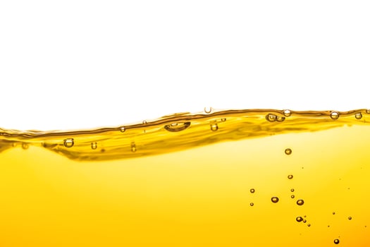 Oil wave background, yellow liquid, and bubbles on white background. photo