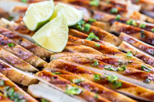 Slices of grilled chicken in lime sauce photo
