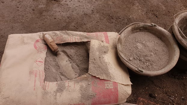 Cement powder in a cardboard bag and a shovel inside photo