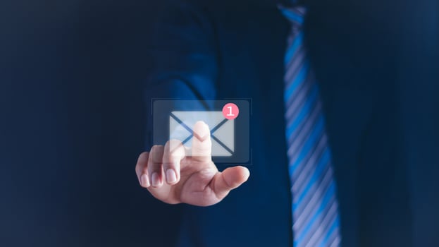 Businessman holding tablet and touching with virtual white newsletter for electronic mail or E-mail with notification alert concept. photo