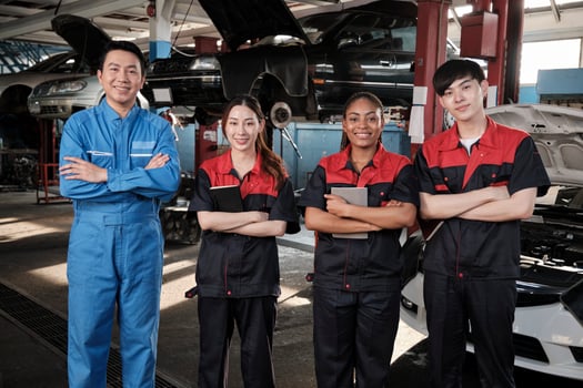 Portrait of multiracial professional mechanic team arms crossed and look at camera, work at car service garage, happy maintenance jobs, check and repair occupation in automotive industry business. photo