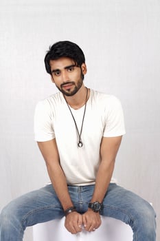 a man sitting on a table with his hands crossed photo