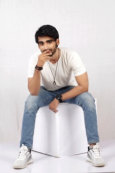 a man sitting on a table with his hands crossed photo
