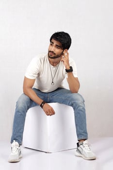 a man sitting on a table with his hands crossed photo