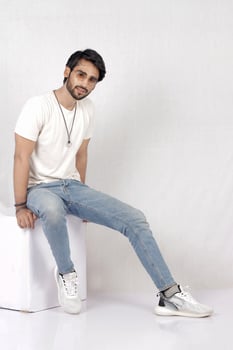 a man sitting on a table with his hands crossed photo