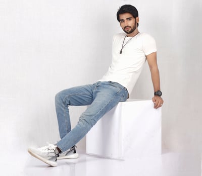 a man sitting on a table with his hands crossed photo