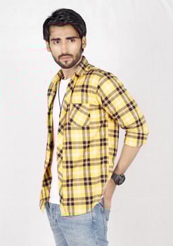 a man in a yellow and black checkered shirt photo