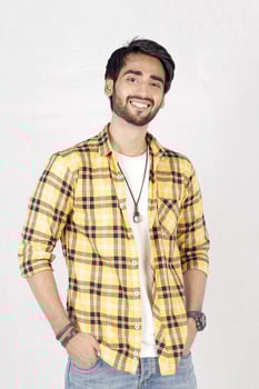 a man in a yellow and black checkered shirt photo