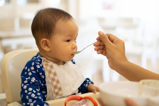 Babies are eating food in 6 month year olds photo