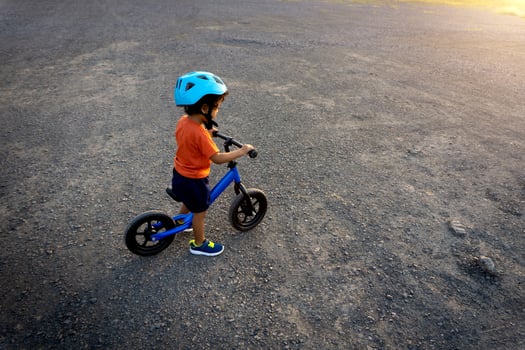 Asian kid first day play balance bike. photo