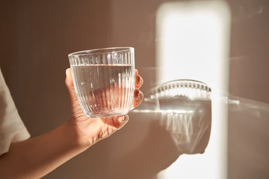 A glass of clean drinking water in the morning sun. photo