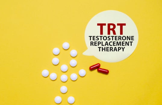 TRT words on sticker with pills man on yellow background photo