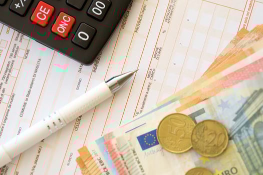 Filling italian tax form process with pen, calculator and euro money bills close up. Tax paying period photo