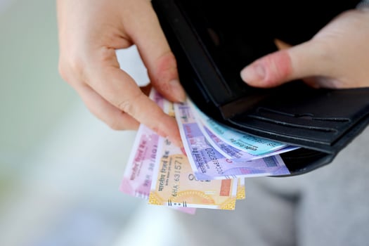 Woman hand with indian rupees bills. Concept of financial operations in cash in India photo