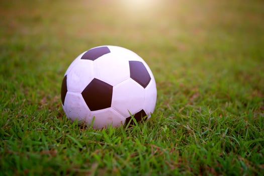 Soccer football at green field in stadium before the match photo