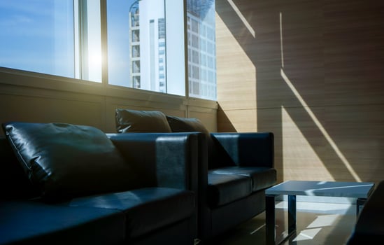Black sofa interior of a waiting room in office and Building view outside photo