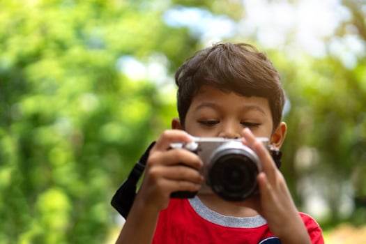 Asian kid use digital camera taking photo