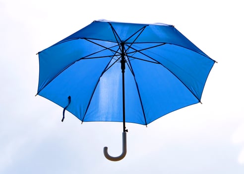 Blue umbrella that was unfolded isolated on white photo