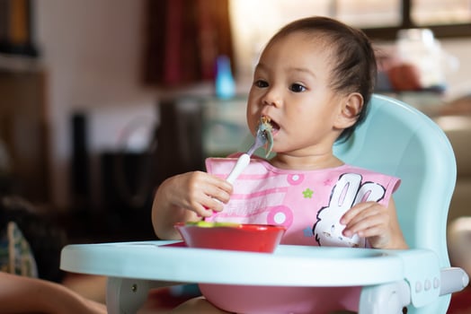Asian baby girl 11 months year old is eating food. photo