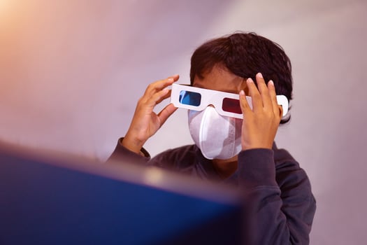 Asian boy uses 3D glasses to watch 3D movies photo