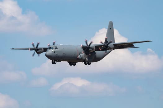 Untitled military transport plane at air base. Airport and airfield. Air force and army flight operation. Aviation and aircraft. Air lift. Military industry. Fly and flying. photo