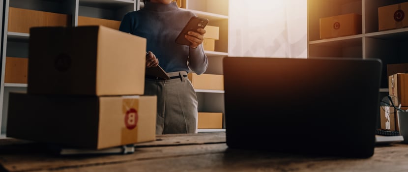Entrepreneurs Small Business SME Independent men work at home Use smartphones and laptops for commercial checking, online marketing, packing boxes, SME sellers, concept, e-commerce team, online sales photo