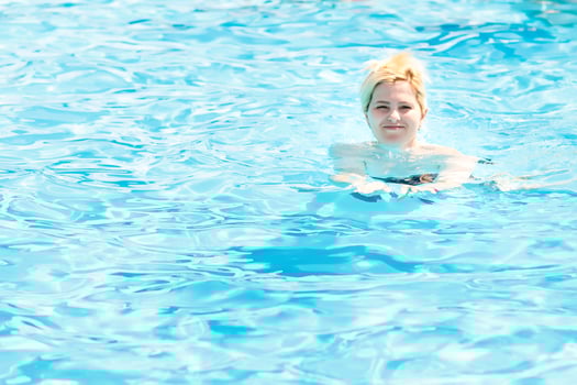 Young woman in the swimming pool photo
