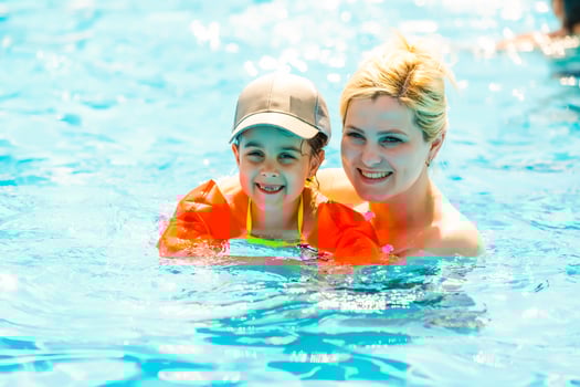 Mother and the daughter at pool, summer holidays photo