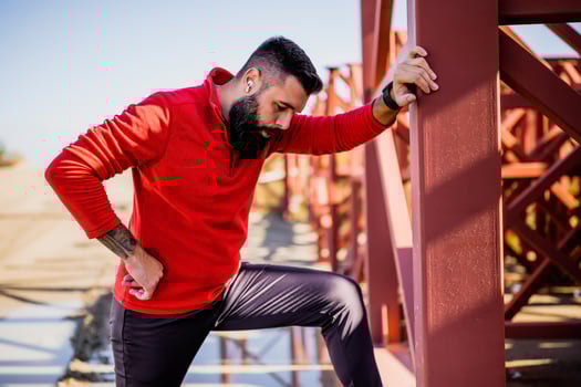 Adult man is relaxing while exercising outdoor on sunny day. photo