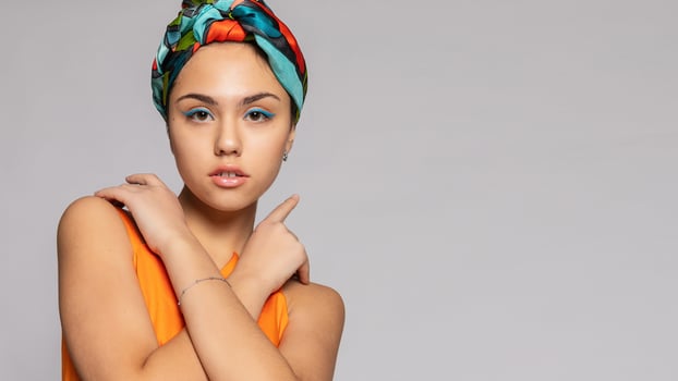 Portrait of a young woman with bright makeup and a fashionable headscarf. photo