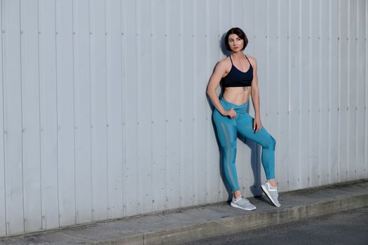 Tough young woman in sports wear staring at camera. photo