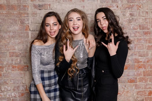 Three female friends posing in front photo