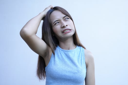 Asian woman has itchy scalp from dandruff photo