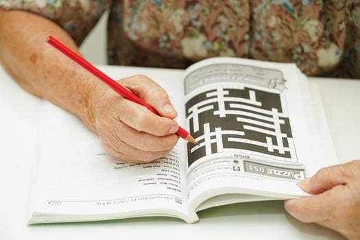 Bangkok, Thailand - May 15, 2022 elderly woman playing sudoku puzzle game for treatment dementia prevention and Alzheimer disease. photo