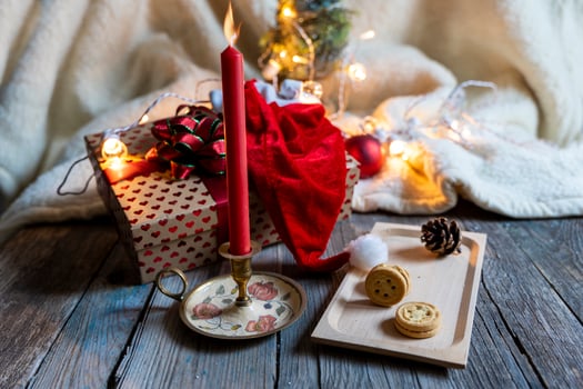 christmas decoration lights and red candle on wooden table photo