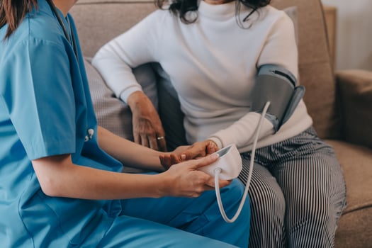 Asian doctor woman visited patient woman to diagnosis and check up health at home or private hospital. Female patient explain health problem and symptoms to doctor .Health care premium service at home photo