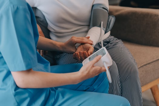 Asian doctor woman visited patient woman to diagnosis and check up health at home or private hospital. Female patient explain health problem and symptoms to doctor .Health care premium service at home photo
