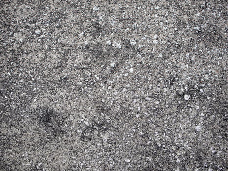 Above view of concrete surface is plastered on the road surface with many rocks mixed in on the ground. For background and textured. photo