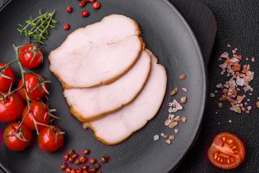 Delicious smoked pork or chicken meat with salt, spices and herbs photo
