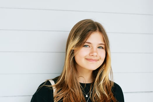 Outdoor close up portrait of pretty young teenage gir with brown hair posing on white background photo
