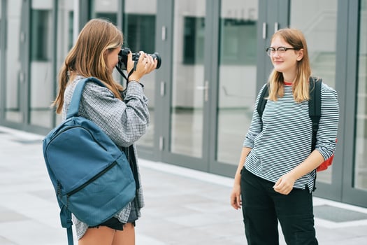 Young teenage girl taking pictures of her friend, hobby and leisure for children photo