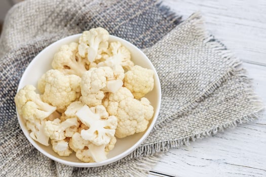 Cauliflower vegetables standing on a white wooden table photo