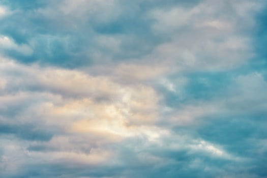 Nature background pastel sky covered with clouds before sunset photo