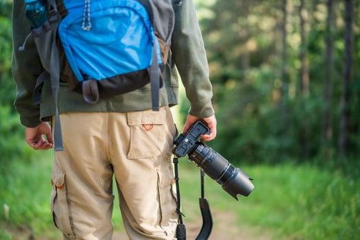 Image of man photographing while hiking in the nature photo