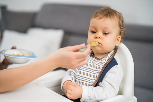 Angry baby boy doesn't want to eat photo