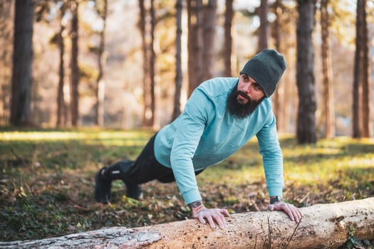 Man with beard enjoys exercising in nature photo